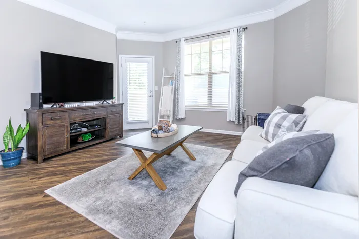 Bright apartment living room with stylish decor and large windows at Corbin Crossing apartments in Overland Park KS