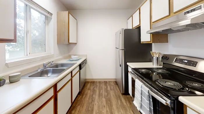 Bright modern kitchen with sleek countertops and stainless appliances at Willow Place student apartments near WSU in Pullman WA