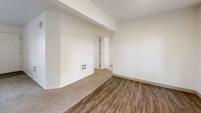 Spacious unfurnished apartment interior with hardwood and carpet flooring at Willow Place student living near WSU in Pullman WA