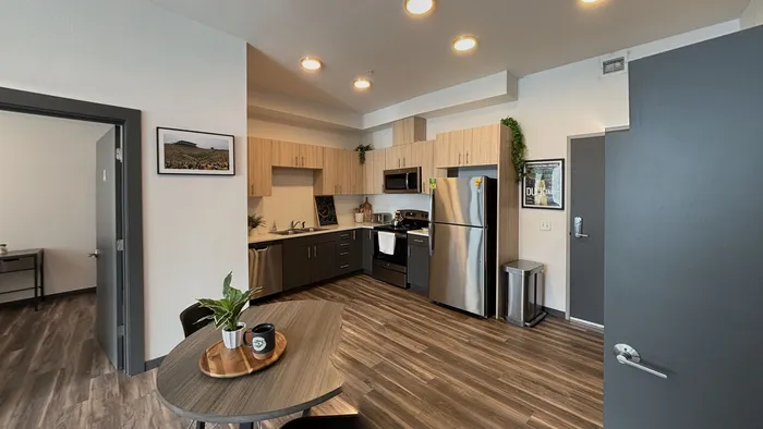 Modern kitchen with wood cabinetry and stainless steel appliances at The Flats at Chase in Eugene, OR