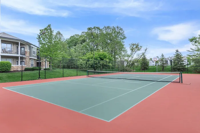 Outdoor tennis court with lush greenery at Corbin Crossing apartments in Overland Park KS