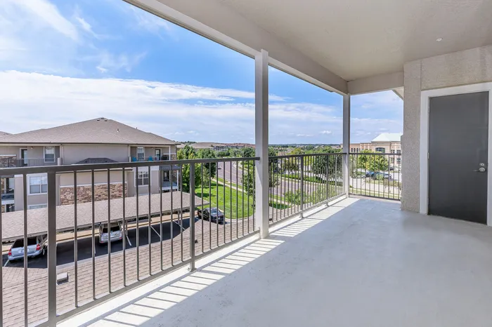 Private apartment balcony with neighborhood views at Corbin Crossing apartments in Overland Park KS