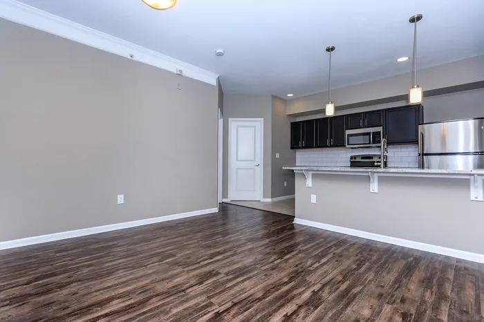 Amherst floor plan kitchen with wood flooring and stainless steel appliances at Corbin Crossing Overland Park KS