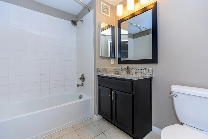 Amherst floor plan bathroom with tile backsplash and granite countertop vanity at Corbin Crossing Overland Park KS
