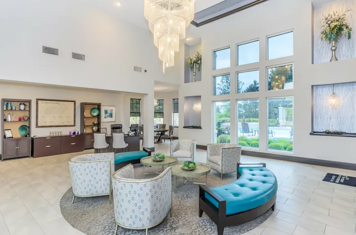 Elegant clubhouse lobby with chandelier and modern decor at Corbin Crossing apartments in Overland Park KS