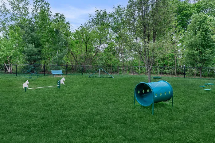 Off-leash bark park with agility equipment and shaded benches at Corbin Crossing Overland Park KS