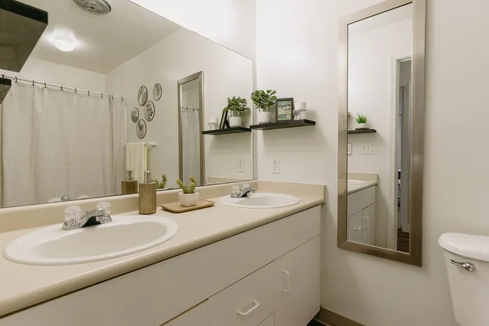 Modern bathroom with twin sinks and refreshing decor at Stadium Park in Eugene OR