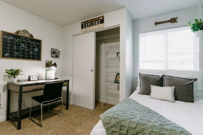 Furnished bedroom with study desk and natural light at Stadium Park in Eugene OR