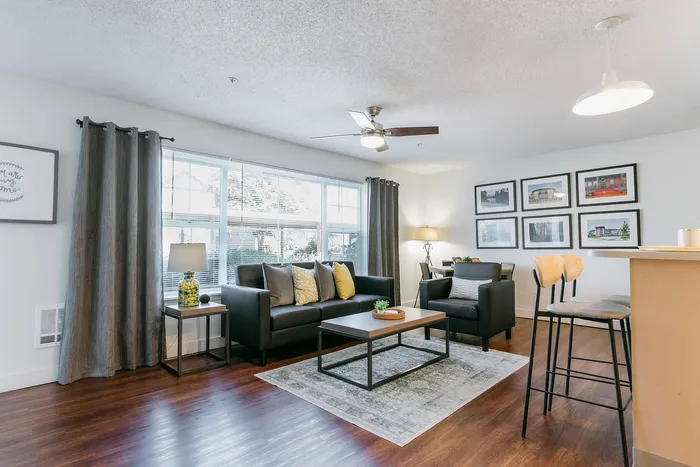 Bright furnished living room with modern furniture at Stadium Park student apartments in Eugene OR