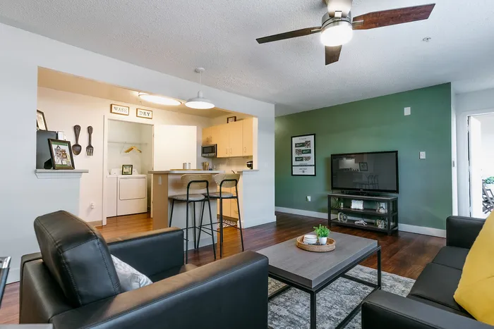 Open-concept living area with kitchen island at Stadium Park student apartments in Eugene OR