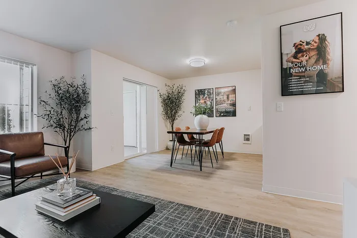 Inviting open-concept dining area with modern decor and natural light, perfect for stylish living and entertaining located at Forest Hills.