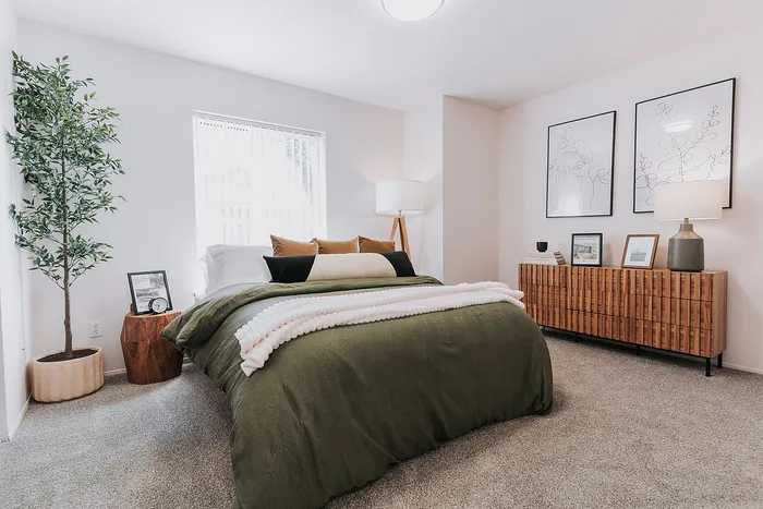Forest Hills bedroom with plush bedding, stylish decor, and natural light, promising a tranquil retreat.