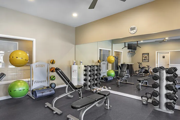 Canyon Springs fully equipped fitness center with weights exercise balls and mirrored walls in Lynnwood WA