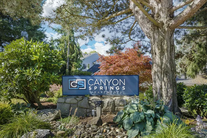 Canyon Springs community entrance surrounded by lush mature trees and beautiful landscaping in Lynnwood WA