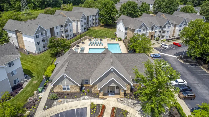 Aerial view of Village Green student apartment community with multiple buildings, central swimming pool, and lush greenery near NC State in Raleigh NC