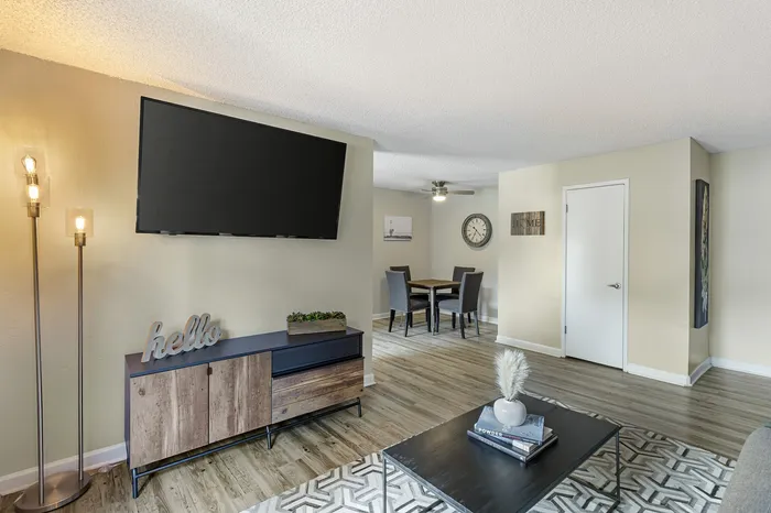The Phoenix Reno elegant living space with flat-screen TV, cozy lighting, and dining area in Reno NV
