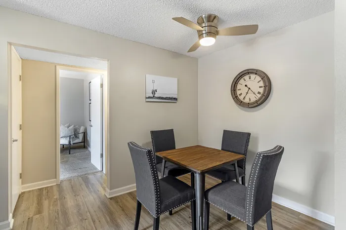 The Phoenix Reno dining area with ceiling fan, wall clock, and elegant dining set on wood flooring in Reno NV
