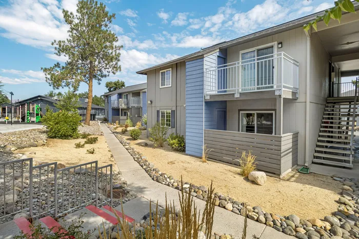The Phoenix Reno apartment exterior with private balconies, landscaped pathways, and community spaces in Reno NV