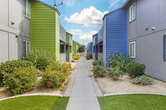 The Phoenix Reno landscaped walkway between colorful apartment buildings in Reno NV