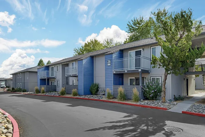 The Phoenix Reno apartment exterior with modern balconies, colorful facade, and lush greenery in Reno NV