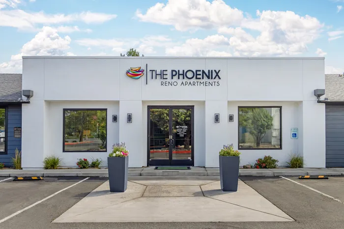 The Phoenix Reno leasing office modern entrance with sleek design and vibrant planters in Reno NV