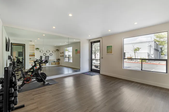 The Phoenix Reno yoga and pilates studio with wooden flooring, stationary bikes, and natural lighting in Reno NV