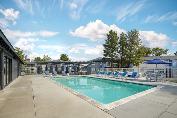 The Phoenix Reno inviting outdoor pool area with modern lounge chairs and shaded pergolas in Reno NV