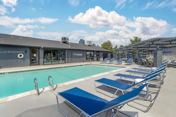 The Phoenix Reno cabana-style pool area with modern loungers and shaded seating in Reno NV