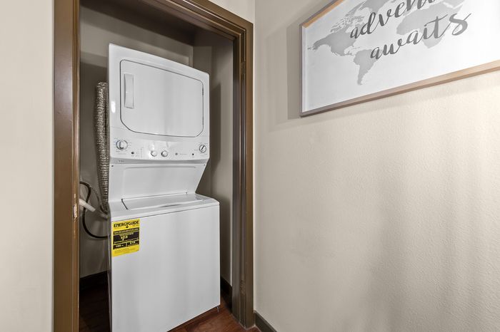 Highlander at North Campus in-unit laundry with modern stacked washer and dryer in Riverside CA