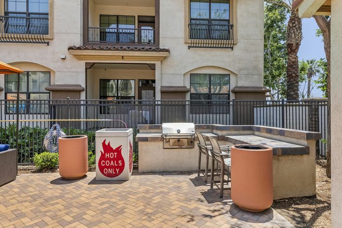 Highlander at North Campus community BBQ area with built-in grill and outdoor patio for resident entertaining in Riverside CA