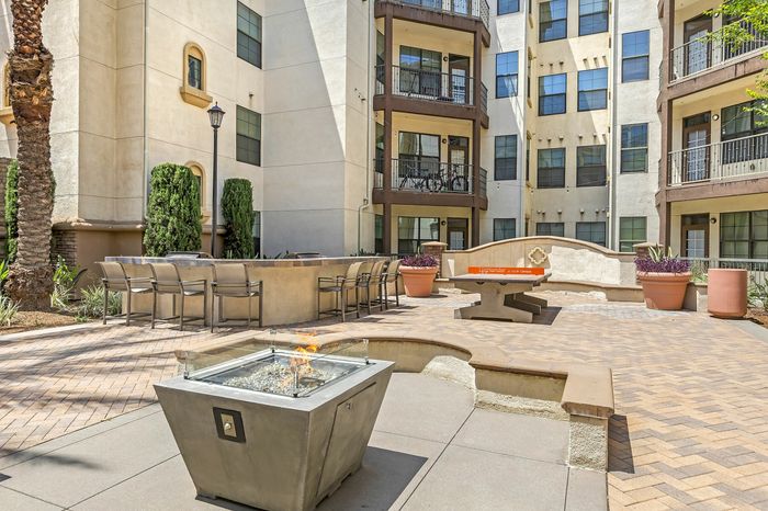 Highlander at North Campus courtyard with modern fire pit, outdoor seating, and greenery perfect for social gatherings in Riverside CA