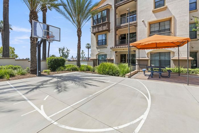 Highlander at North Campus basketball court with shaded picnic area and lush greenery in Riverside CA