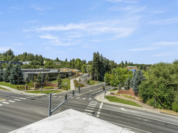 Scenic view from Republic on Main apartment showcasing lush greenery, tree-lined streets, and a vibrant neighborhood under a clear blue sky in Moscow, ID