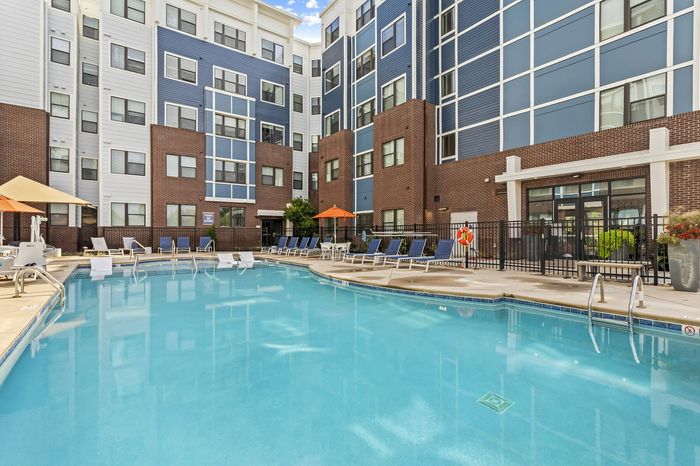 303 Flats resort-style swimming pool with sparkling blue water and lounge seating in Knoxville TN