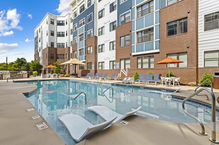 303 Flats outdoor pool with umbrella-shaded lounge chairs for relaxing in Knoxville TN