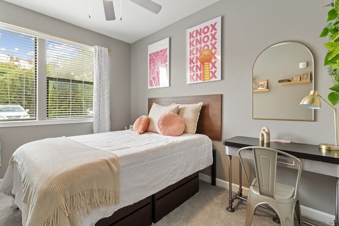 303 Flats model bedroom with modern furnishings and ample closet space in Knoxville Tennessee student apartment