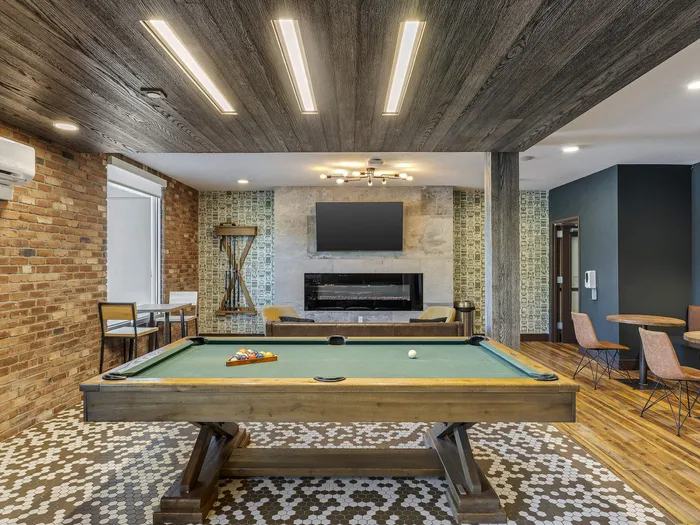 Republic on Main game room with a sleek pool table, cozy brick accents, and ambient lighting for a perfect hangout spot in Moscow, ID