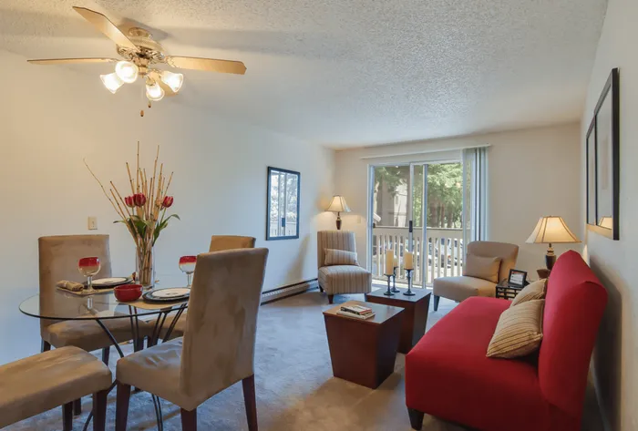 Maplewood Park and dining area with plush seating, stylish decor, and abundant natural light from the glass doors opening to a serene balcony.