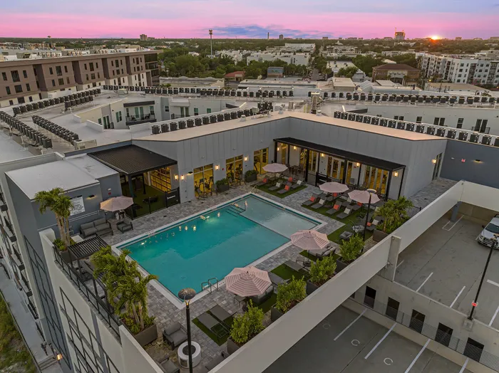 Resort-style pool with sun loungers at Niche luxury apartments in Tampa, FL
