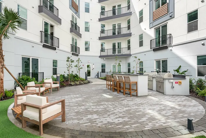 Outdoor kitchen and courtyard lounge space at Niche luxury apartments in Tampa, FL