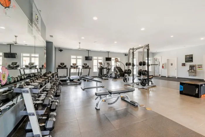 Spacious 24/7 fitness center with modern equipment and natural lighting at The Cottages on Lindberg in West Lafayette, IN