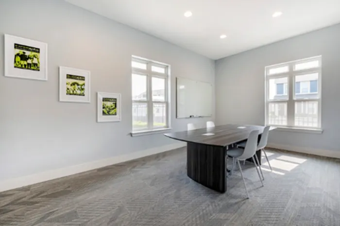 Bright study room with stylish wall art and large windows at The Cottages on Lindberg in West Lafayette, IN
