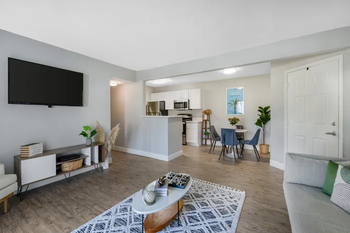 The Phoenix Orlando apartments living room with hanging television and natural lighting
