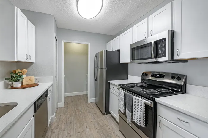 The Phoenix Orlando apartment interior kitchen with Stove, Microwave and Refrigerator