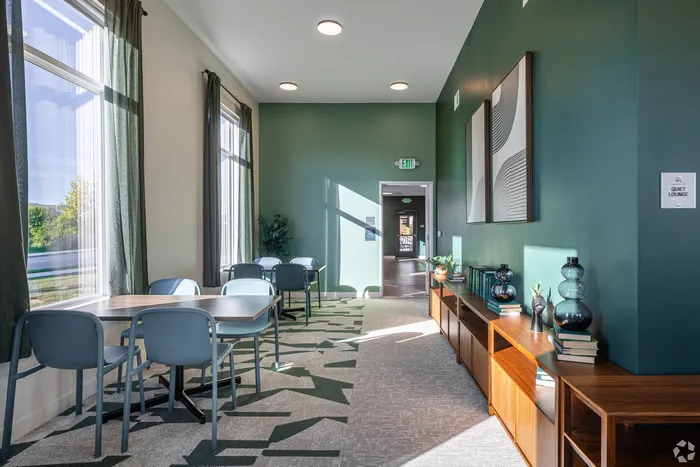 Bright and inviting lounge area with modern decor, natural light, and sleek furnishings, ideal for relaxation or social gatherings.