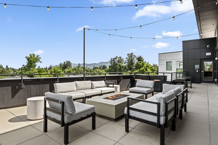 Inviting terrace featuring modern outdoor seating, cozy fire pit, and panoramic mountain views, perfect for relaxation and gatherings.