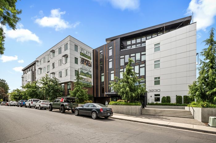 Modern apartment building with sleek design, abundant natural light, and lush greenery at Flats @ Chase.
