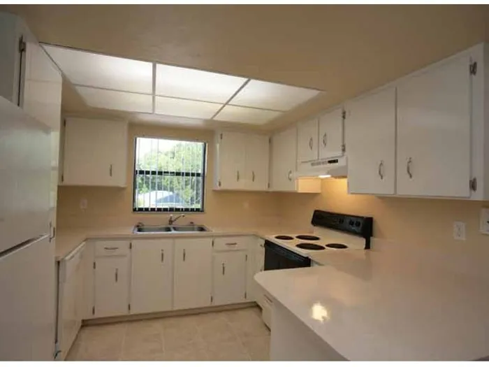 Marcell Gardens Apartments, interior, kitchen, white cabinets and appliances,