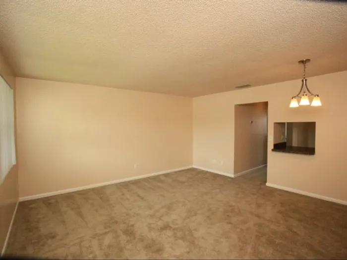 Marcell Gardens Apartments, interior, living room, spacious, carpet, pass through to kitchen
