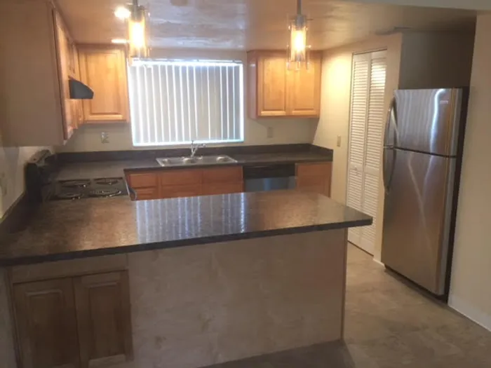Marcell Gardens Apartments, interior, kitchen, peninsula counter, stainless steel appliances, window,
